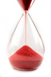 Sand timer with red sand | Featured image for Outsourcing Transcription Services is Easy on Pacific Transcription.