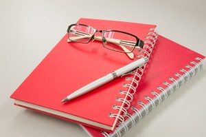 eye glasses with notebook and pen