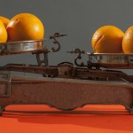 Oranges being weighed on an old scale | Featured image for What’s the Difference Between Dictaphones and Voice Records blog for Pacific Transcription.