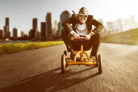 Man wearing goggles while riding a derby cart | Featured image for Audio for Methods of Receiving Audio for Transcription blog for Pacific Transcription.