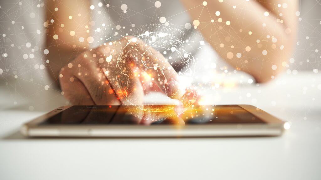 Photo of person scrolling an Ipad with their finger with the image of a interconnected points overlaying it | featured image for FAQS.