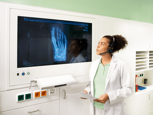 Photo of female doctor transcribing an x-ray of a foot | featured image for Philips SpeechOne PSM6800.