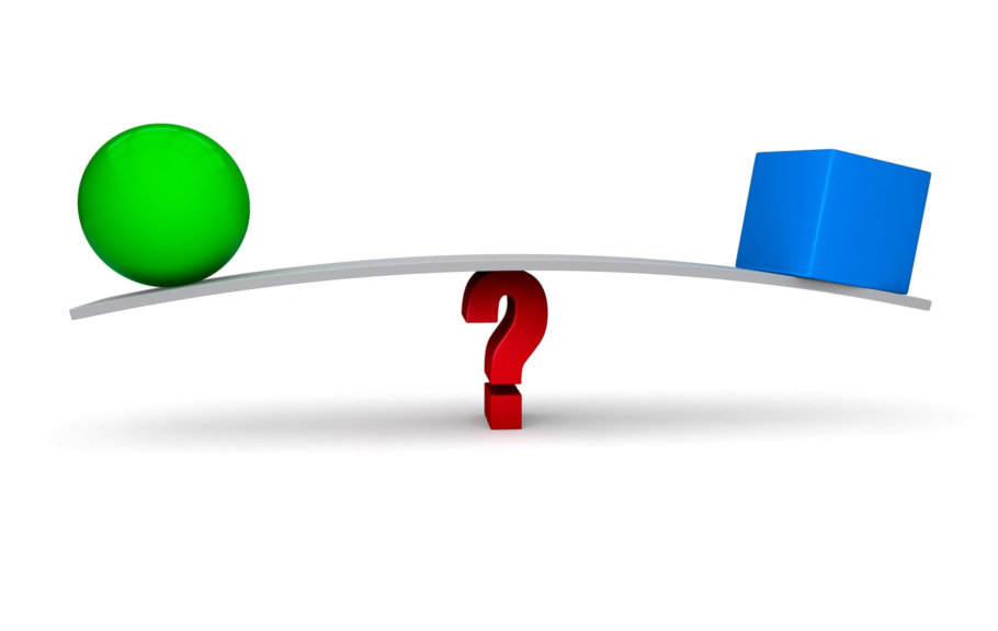 Weighing the difference between a green ball and a blue square, balancing on a board | Featured image for blog article Is there a difference between dictation and transcription software?