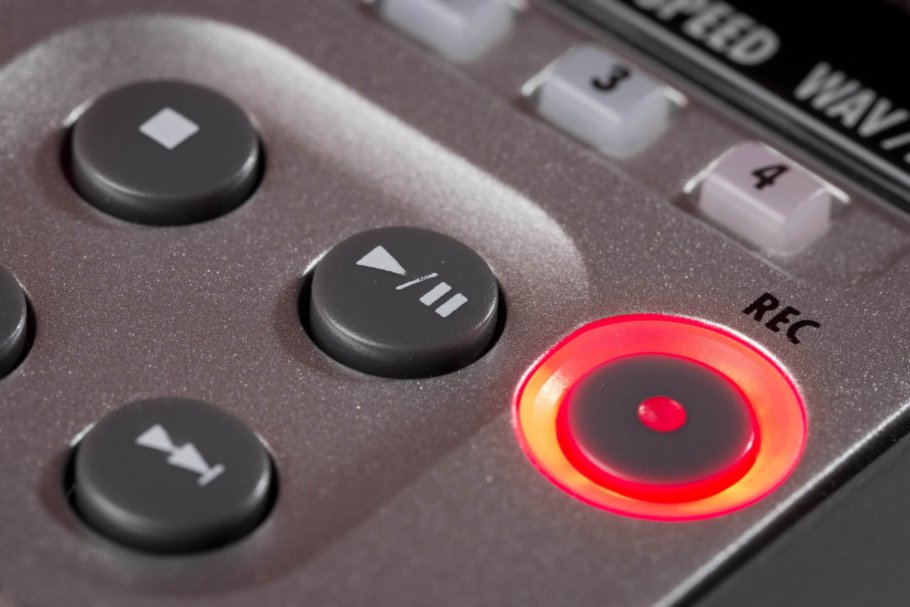 Close up of a recording device, with the record button glowing red, showing the device is now recording | Featured image for Is a Dictaphone the right product for you? blog by Pacific Transcription.