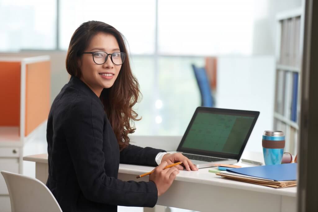 Young lawyer smiling at camera - Legal Transcription | featured image for Legal & Court and VCAT Transcript Services