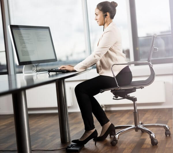 Professional Typist working on her computer | featured image for Olympus Premium Dictation and Transcription Bundle.