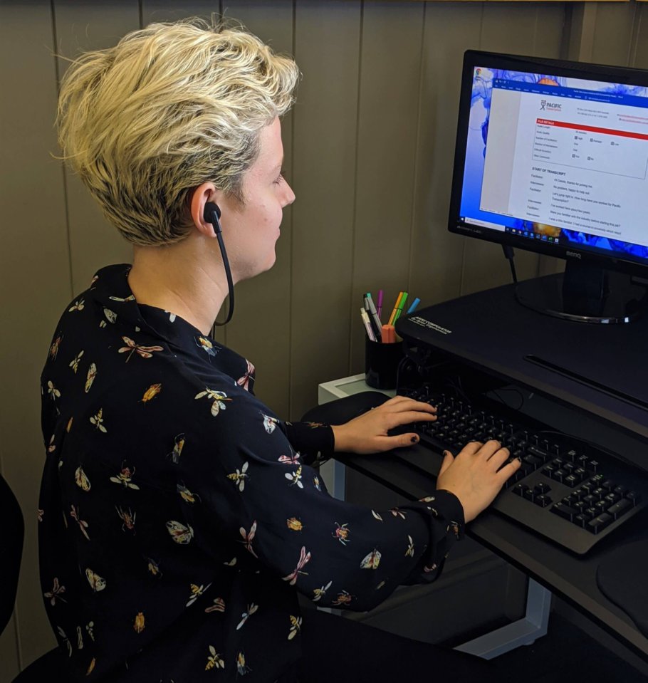 Employee using E-103 Headphones | featured image for What You Need to Become a Professional Typist.