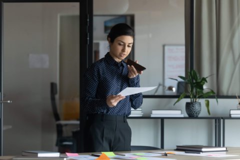 Photo of a woman using a smartphone to record audio. | Featured image for Using Your Smartphone to Record Audio is Easy Blog for Pacific Transcription.